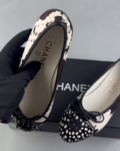 Chanel ballet flats feature a black and white cow print design — 5