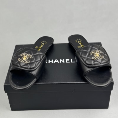 Chanel black quilted slides are crafted from leather — 4