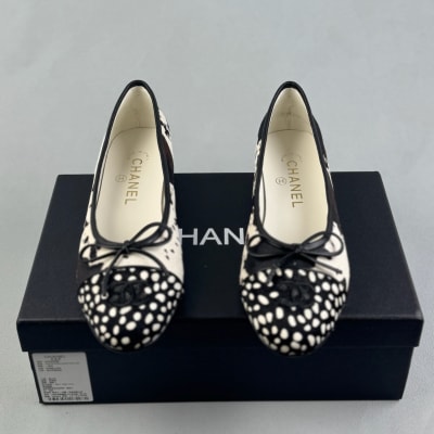 Chanel ballet flats feature a black and white cow print design — 3