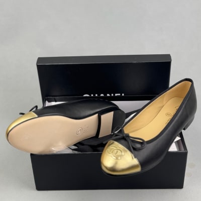 Chanel black leather ballet flats with gold cap toes