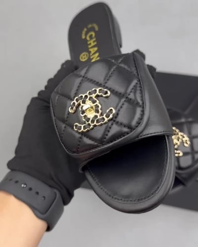 Chanel black quilted slides are crafted from leather — 5