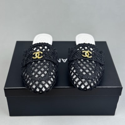 Chanel black mules feature a intricate woven design with gold-tone CC logos on the front — 3