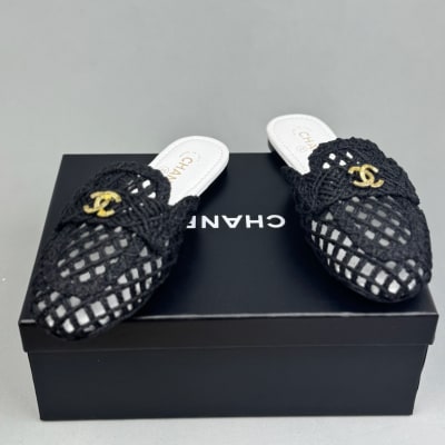 Chanel black mules feature a intricate woven design with gold-tone CC logos on the front — 4