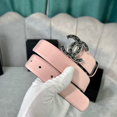 Chanel belt features a pale pink leather strap paired with a distinct black and gold CC logo buckle — 7