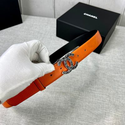 Chanel orange belt features a textured leather strap and a distinctive CC logo buckle — 6