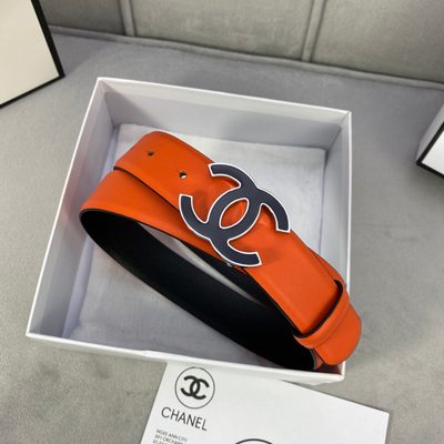 Chanel belt features vibrant orange leather and a distinctive interlocking CC buckle with a navy blu — 4
