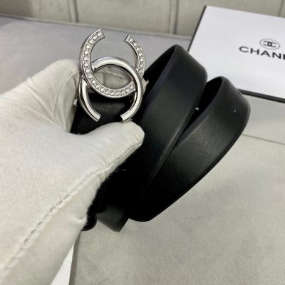 Chanel belt features a distinctive black leather strap paired with a gold-tone CC logo buckle — 6