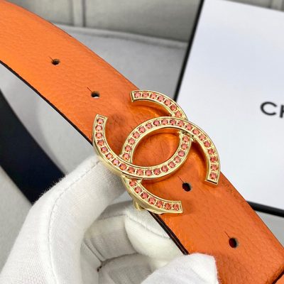 Chanel belt features textured orange leather and a silver CC logo buckle detailed with orange stones — 6