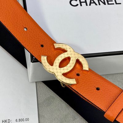 Chanel leather belt features a vibrant orange texture and a silver-toned interlocking CC buckle — 5