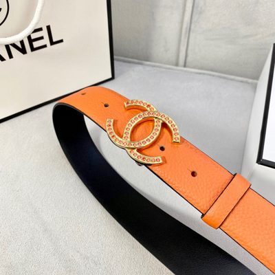 Chanel belt features textured orange leather and a silver CC logo buckle detailed with orange stones — 5