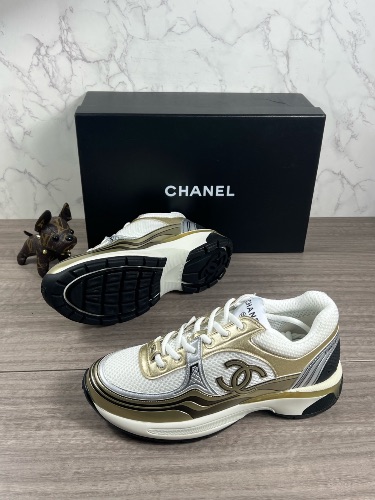 Chanel CC Runner sneakers in a white, gold, and silver