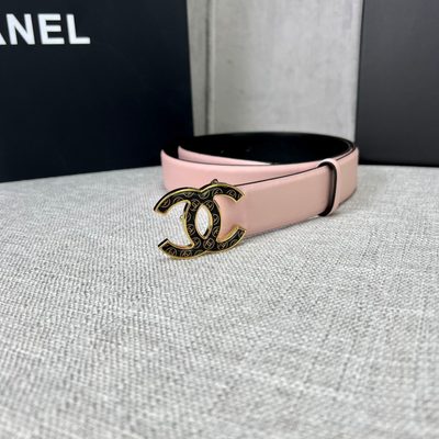 Chanel belt features a pale pink leather strap paired with a distinct black and gold CC logo buckle — 3