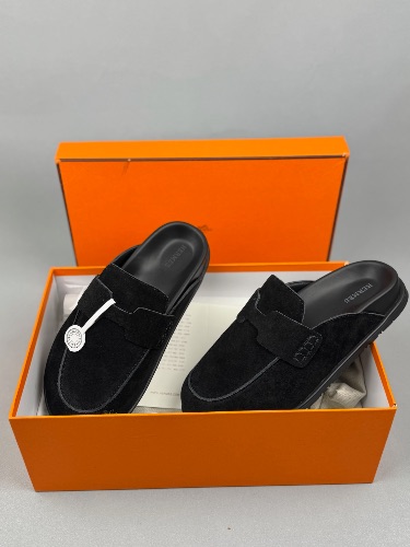 Hermès Go Mules featuring a penny strap design and white stitching details
