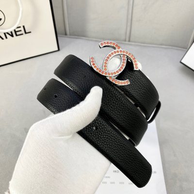 Chanel belt features a black grained leather strap and a gold-tone CC buckle embellished with orange — 8