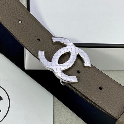 Chanel belt features a taupe-colored grained leather strap and a gold-tone "CC" logo buckle — 8