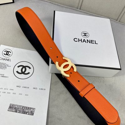 Chanel leather belt features a vibrant orange texture and a silver-toned interlocking CC buckle — 4