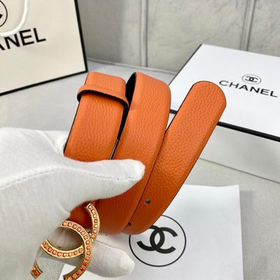 Chanel belt features textured orange leather and a silver CC logo buckle detailed with orange stones — 7