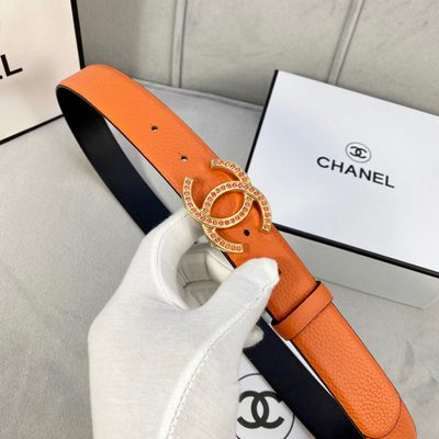 Chanel belt features textured orange leather and a silver CC logo buckle detailed with orange stones — 4