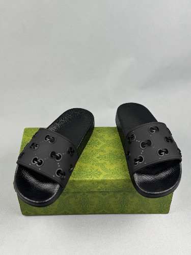 Gucci women's GG rubber slides in black — 4