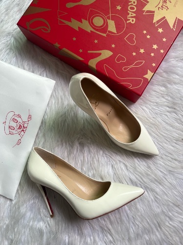 Christian Louboutin white patent leather pumps