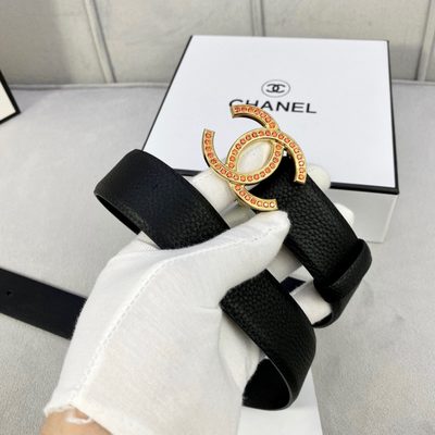 Chanel belt features a black grained leather strap and a gold-tone CC buckle embellished with orange — 4