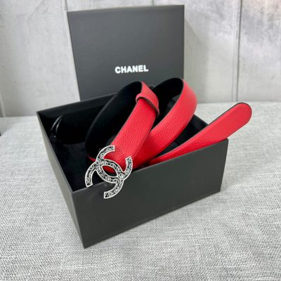 Chanel leather belt features a vibrant red calfskin strap and a distinctive silver CC logo buckle — 4