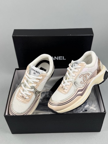 Chanel CC Runner sneakers in a white, beige, and gold colorway