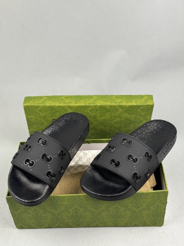 Gucci women's GG rubber slides in black