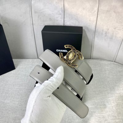 Chanel grey leather belt featuring a distinctive patterned silver-tone CC logo buckle — 8