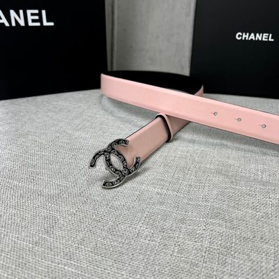 Chanel belt features a pale pink leather strap paired with a distinct black and gold CC logo buckle — 9