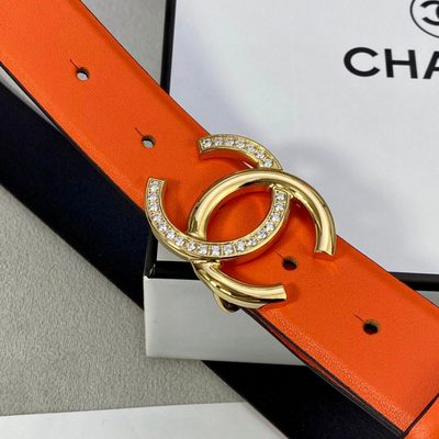 Chanel women's belt features a vibrant orange leather strap paired with a silver-tone, rhinestone-em — 7