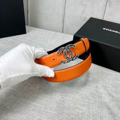 Chanel orange belt features a textured leather strap and a distinctive CC logo buckle — 9