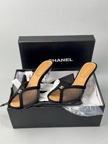 Chanel black mesh peep-toe mules featuring transparent heels and gold CC logo accents