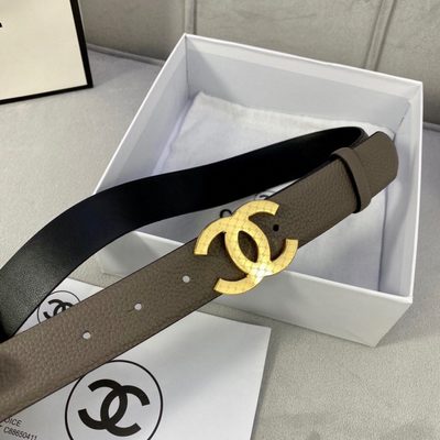 Chanel belt features a taupe-colored grained leather strap and a gold-tone "CC" logo buckle — 5