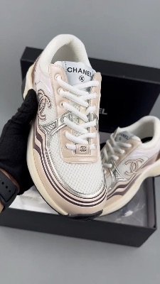 Chanel CC Runner sneakers in a white, beige, and gold colorway — 5