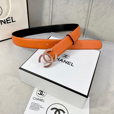 Chanel belt features textured orange leather and a silver CC logo buckle detailed with orange stones — 3