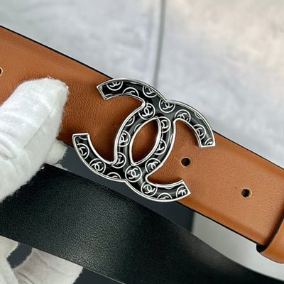 Chanel C100 belt features a distinctive black and gold CC logo buckle — 8