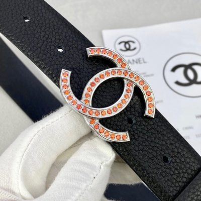 Chanel belt features a black grained leather strap and a gold-tone CC buckle embellished with orange — 7