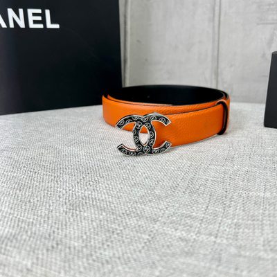 Chanel orange belt features a textured leather strap and a distinctive CC logo buckle — 8