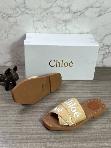 These are Chloé Woody sandals featuring beige logo-embroidered canvas crossover straps