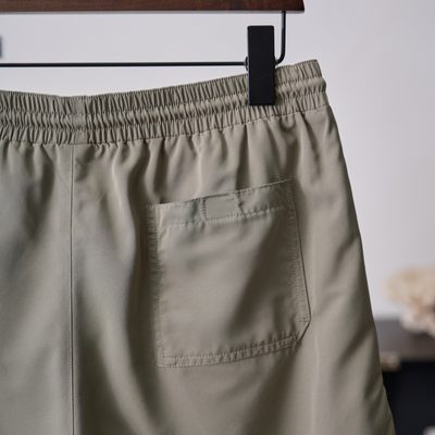 Brunello Cucinelli sage green swim shorts — 9