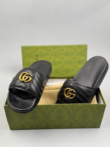 Gucci Black Leather GG Marmont Slides featuring a gold-toned Double G logo