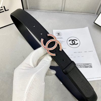 Chanel belt features a black grained leather strap and a gold-tone CC buckle embellished with orange — 5