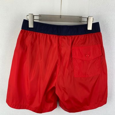 Moncler logo patch swim shorts in red — 3