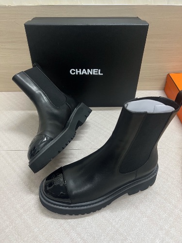 Chanel 22A black calfskin and patent leather cap-toe ankle boots