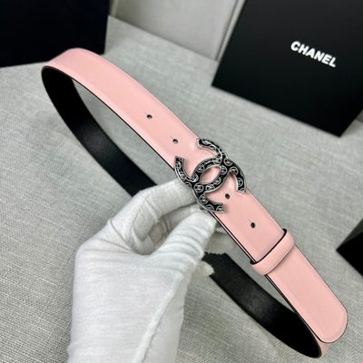 Chanel belt features a pale pink leather strap paired with a distinct black and gold CC logo buckle — 6
