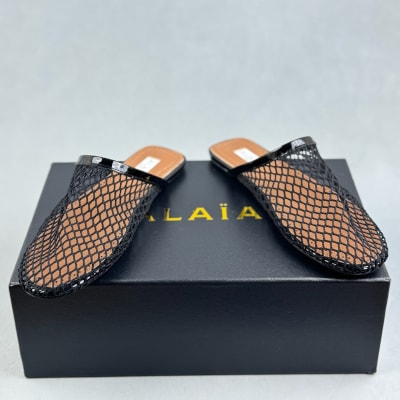 Alaïa black fishnet mules are flat slip-on — 4