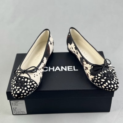 Chanel ballet flats feature a black and white cow print design — 4