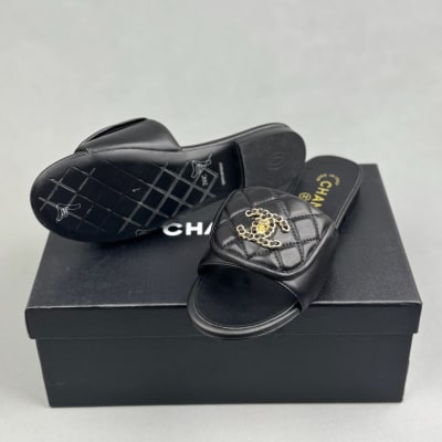 Chanel black quilted slides are crafted from leather