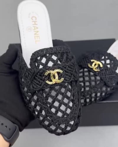 Chanel black mules feature a intricate woven design with gold-tone CC logos on the front — 5